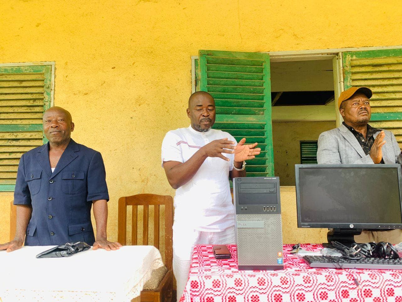 Community leaders presenting donated computers to the school