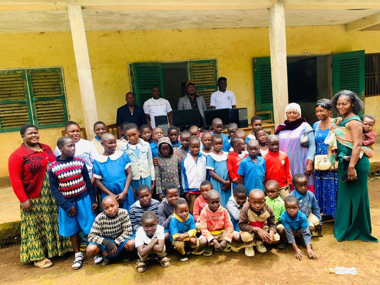 MAMFO team with pupils and donated computers at a community school